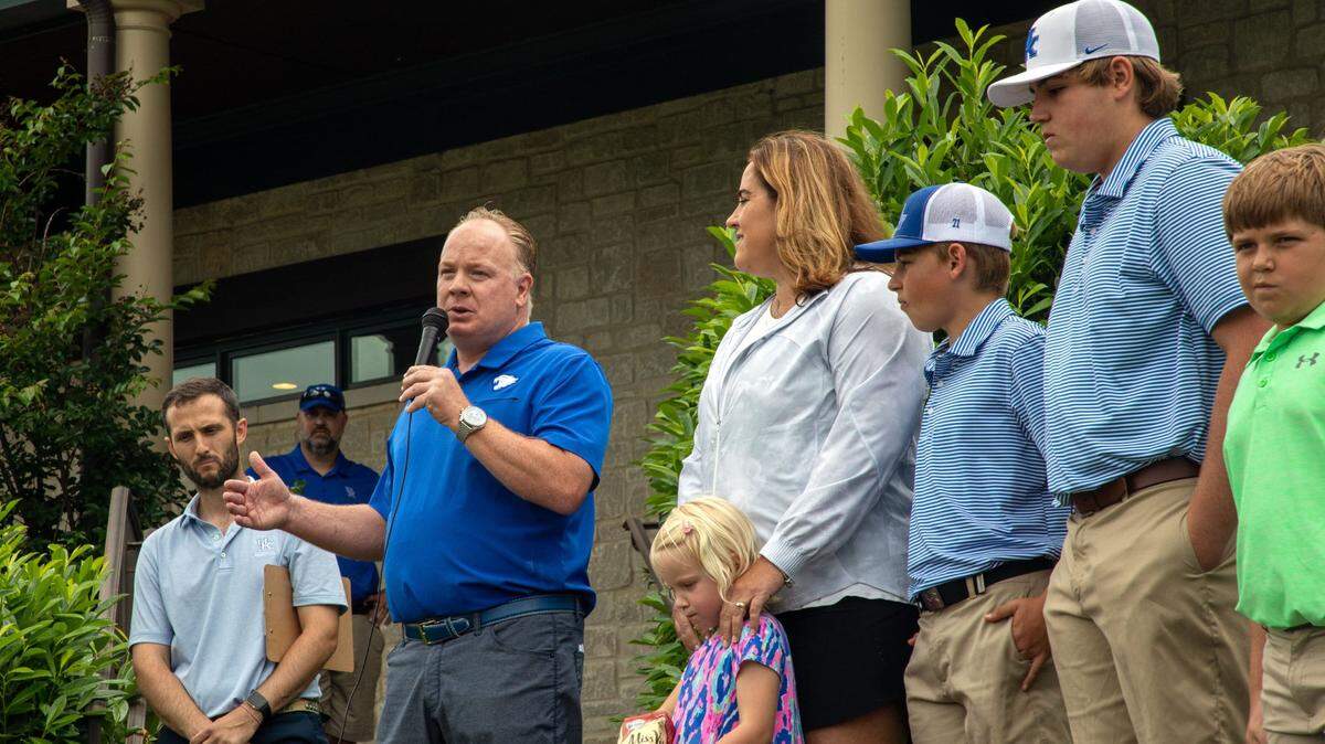 Kentucky football coach Mark Stoops, alongside LeeAnne Schlarman and her children, spoke at the Schlarman Strong/Kentucky Football Alumni golf scramble at Keene Trace Golf Club in Nicholasville.