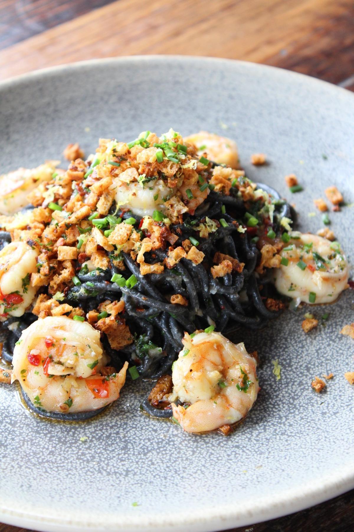 Crust’s spicy Scampi pasta ($22) is made with squid ink tonnarelli pasta, shrimp, calabrian chilies, garlic, preserved lemon and is finished with garlic herb breadcrumbs.