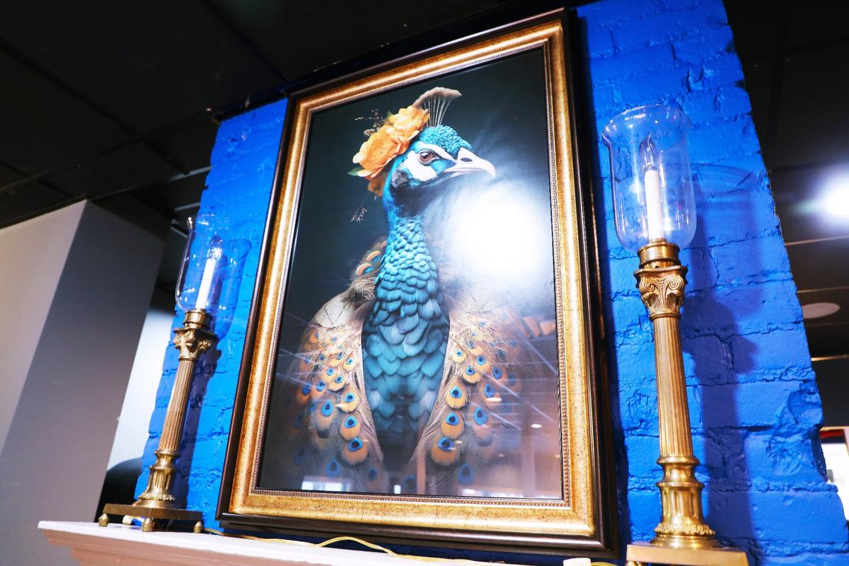 A peacock portrait serves as inspiration for the new Southern soul food restaurant, Sassy Bleu.