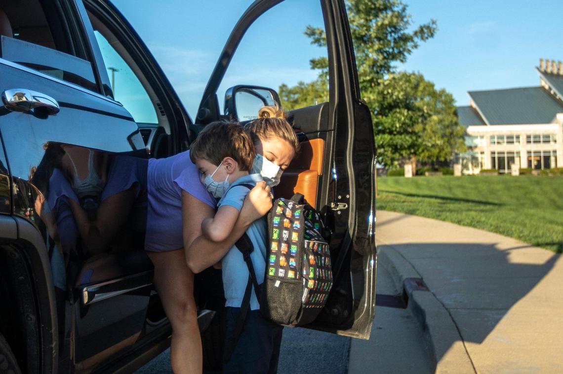 Shawna Mann hugs her son, Rowan, 5, a kindergarten student, as she drops him off at Good Shepherd Catholic School in Frankfort, Ky., on the first day of school, Monday, Aug. 17, 2020.