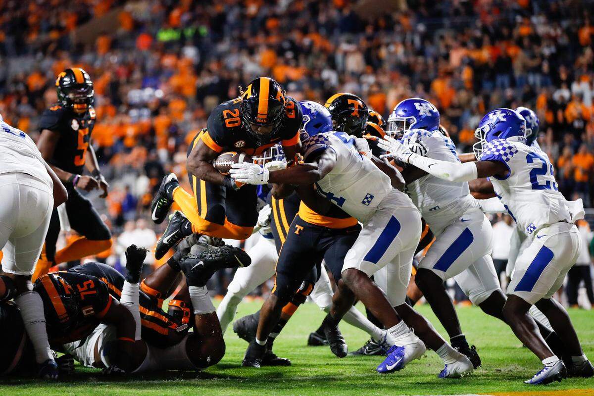 Tennessee Volunteers running back Jaylen Wright (20) jumps over the Kentucky Wildcats defense to score a touchdown during the game at Neyland Stadium in Knoxville, Tn., Saturday, October 29, 2022.