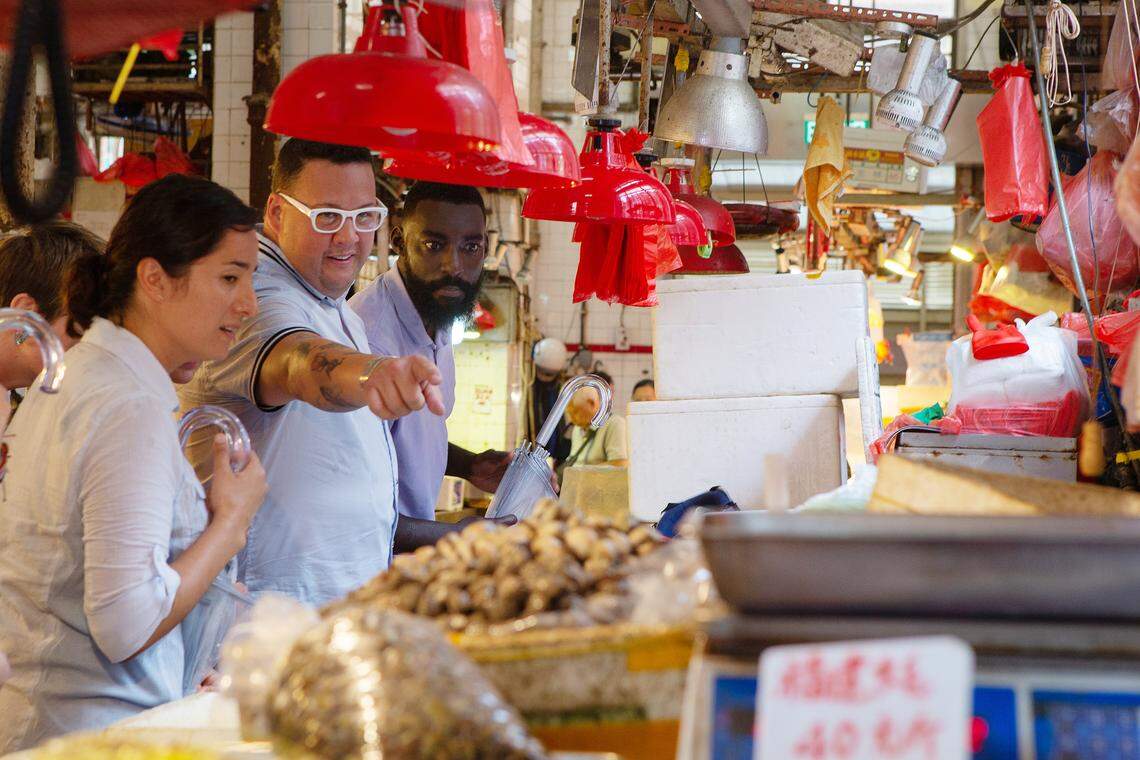 “Top Chef” contestants Michelle Minori and Eric Adjepong tour the Macau market with judge Graham Elliot.