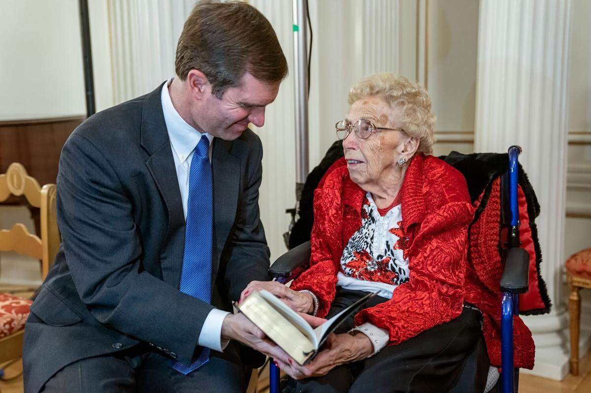After his private swearing-in ceremony last Dec. 10 at the Governor’s Mansion to become governor of Kentucky, Gov. Andy Beshear showed to Rita Grace Ridley of Dawson Springs a Bible she had given him when he was seven. He referred to her as his “second mother.”