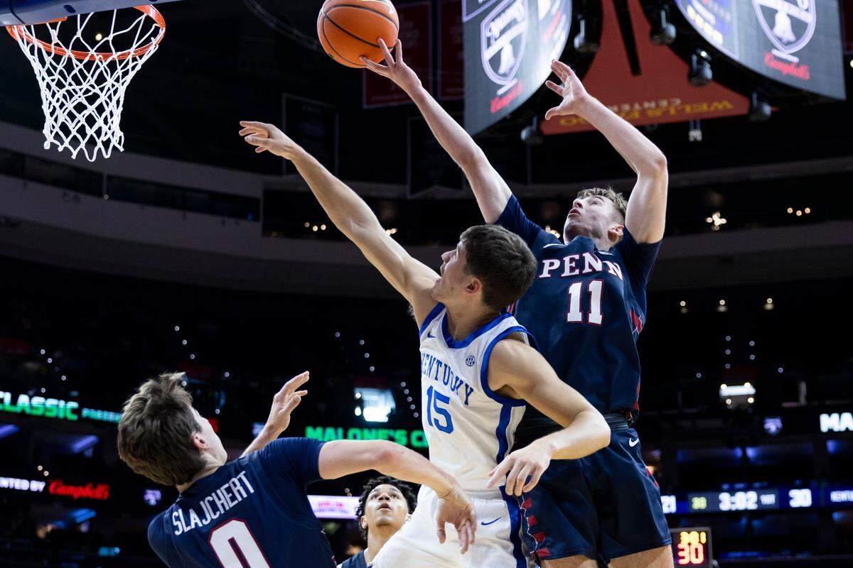 Kentucky guard Reed Sheppard (15) reaches for a rebound against Pennsylvania guard Sam Brown (11).