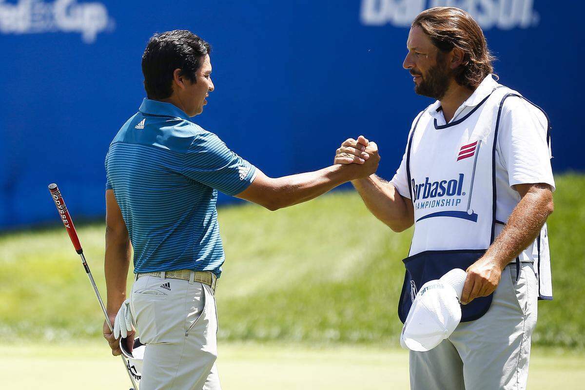 Andres Romero, left, celebrated with caddy Angel Monguzzzi after sinking a putt on the 18th green during the PGA Tour Barbasol Championship at Keene Trace Golf Club Thursday in Nicholasville. Romero finished 7 under for the day. 