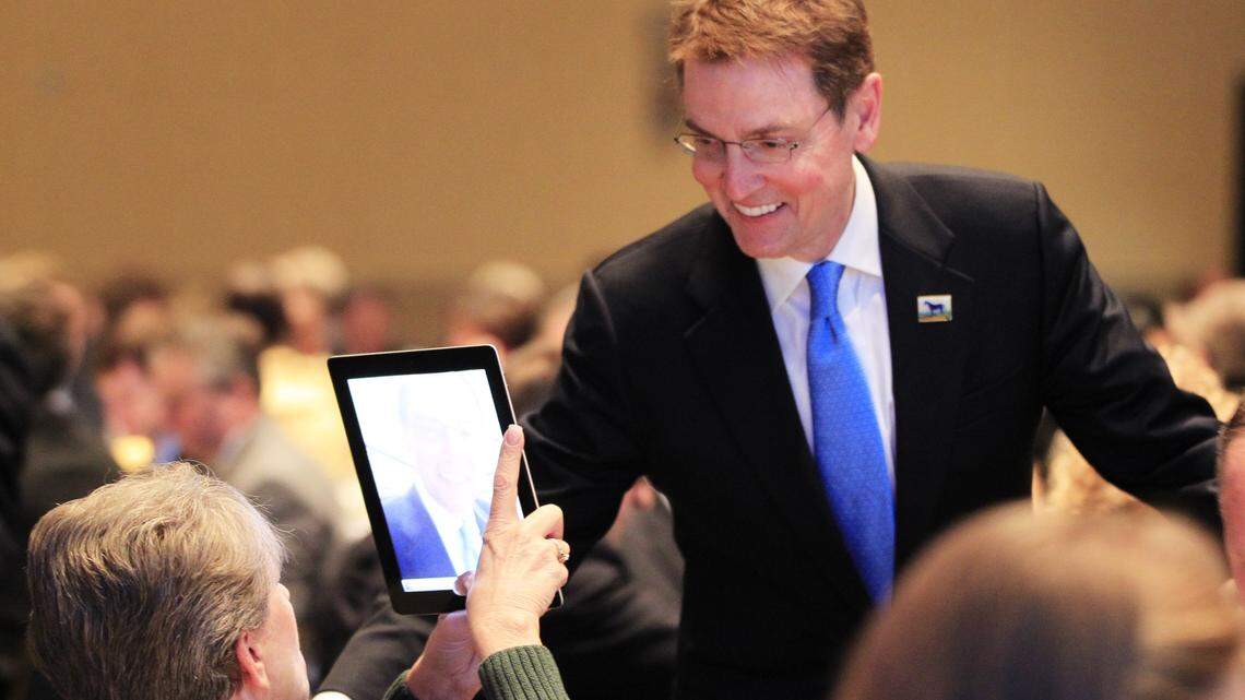 Pam Brandonburg, president of CSEA, AFSCME local 3562, the fire fighter's union, and a Fire Dept. employee used her tablet to photograph Mayor JIm Gray during the Lexington Forum luncheon where the mayor's State of the Merged Government speech was the key address at the Lexington Center in Lexington, Ky., on Jan. 24, 2012.  Photo by Pablo Alcala | Staff     