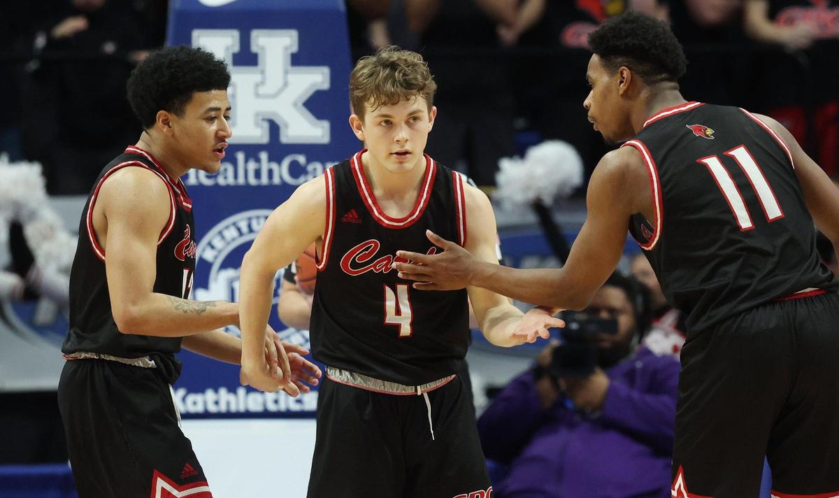 Clark County’s Aden Slone (4) is congratulated by teammates after hitting his free throws in overtime of the semifinals of the Boys’ Sweet 16 at Rupp Arena.