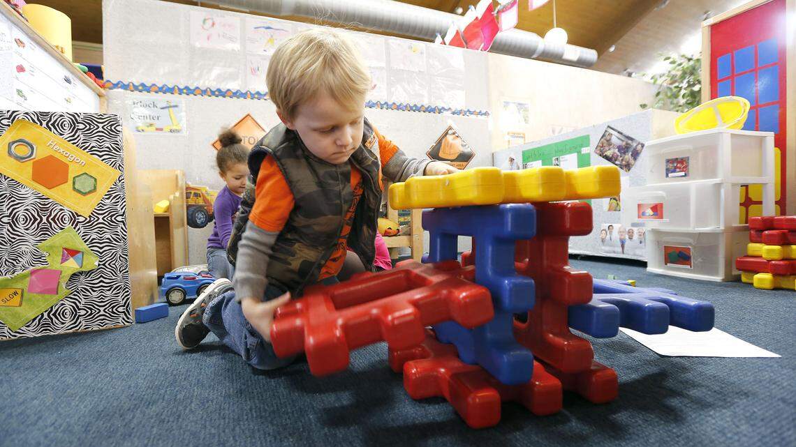  Landon Barker played made a structure as Aminata Sebor played in the background at the Big Blue Bird Early Childhood Center, 1945 Eastland Pkwy in Lexington Ky., Wednesday, December 18, 2013. Big Blue Bird on Eastland Parkway has lost more than 40 kids in six months because of cuts to the child care assistance program -- a subsidy that pays for child care for working parents. Both of the kids are 4-years-old and are in the Pre-K class. Photo by Charles Bertram | Staff