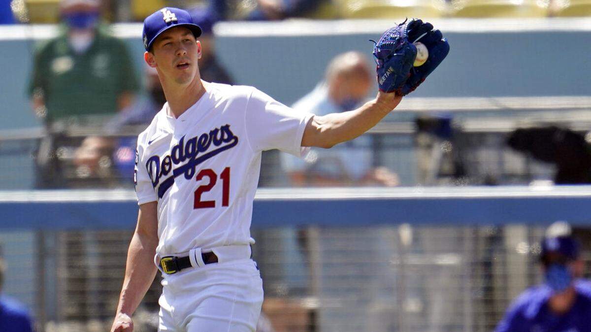 Los Angeles Dodgers starting pitcher Walker Buehler gets the ball back from the infield after recording an out during the fourth inning of a baseball game against the Washington Nationals, Friday, April 9, 2021, in Los Angeles. (AP Photo/Marcio Jose Sanchez)