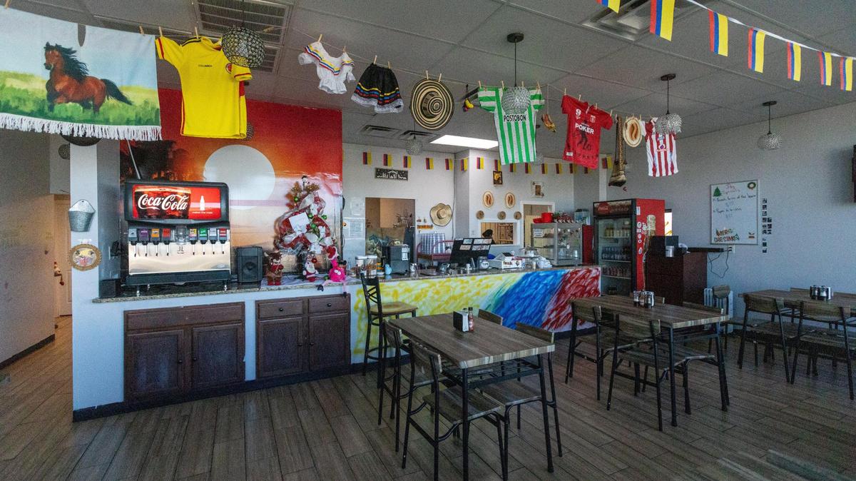 The dining room of The Colombian Corner restaurant in Lawrenceburg is decorated with soccer jerseys and native Colombian attire.