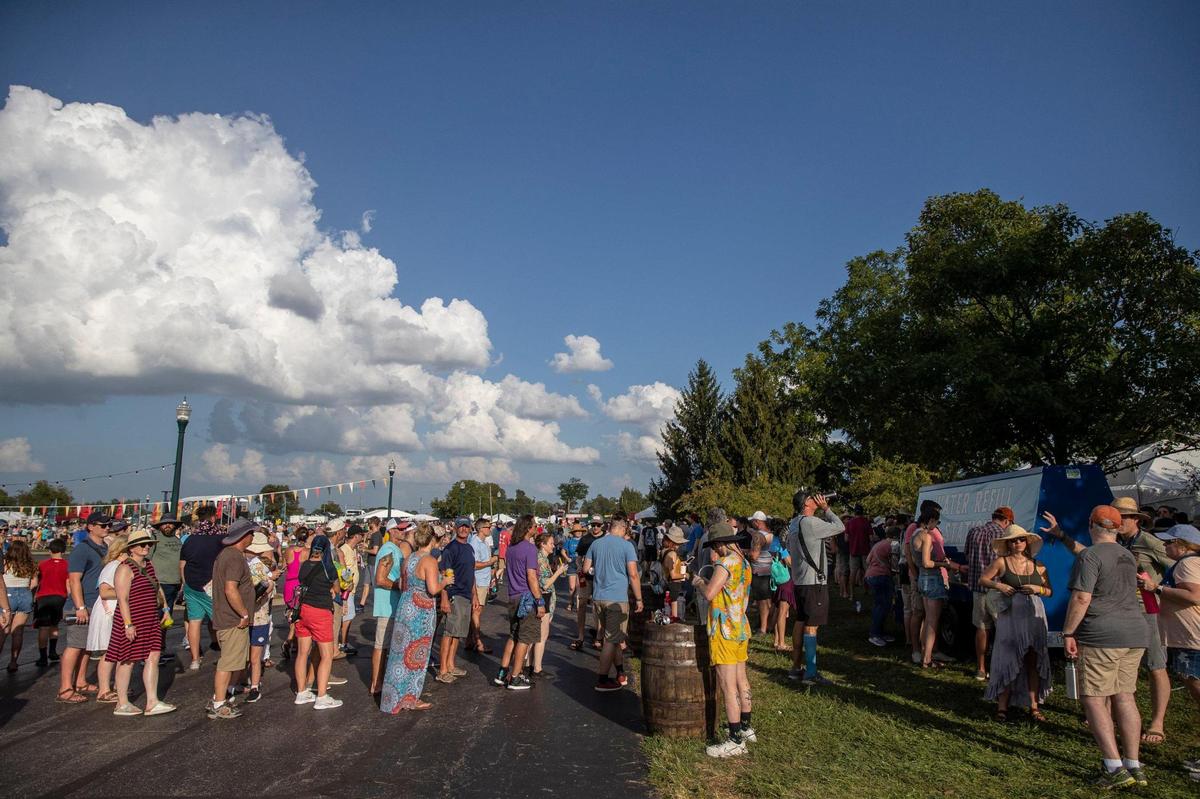 People wait in line to get water at a water refill station at the Railbird Music Festival at Keeneland in Lexington, Ky., on Saturday, Aug. 28, 2021.