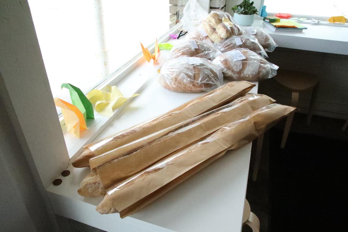 Freshly baked French baguettes and sourdough bread adorn the window at Wilson’s Grocery on May 23, 2024, in Lexington, Ky.