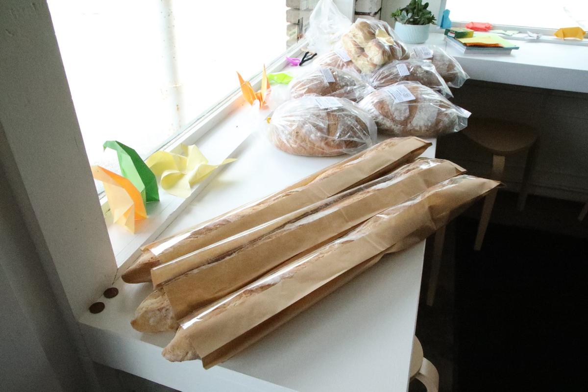 Freshly baked French baguettes and sourdough bread adorn the window at Wilson’s Grocery on May 23, 2024, in Lexington, Ky.