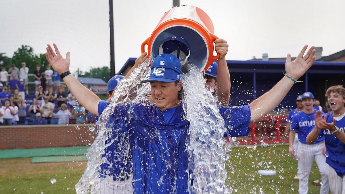 Lexington Catholic head coach Scott Downs is doused with water after winning the 11th Regional baseball championship.