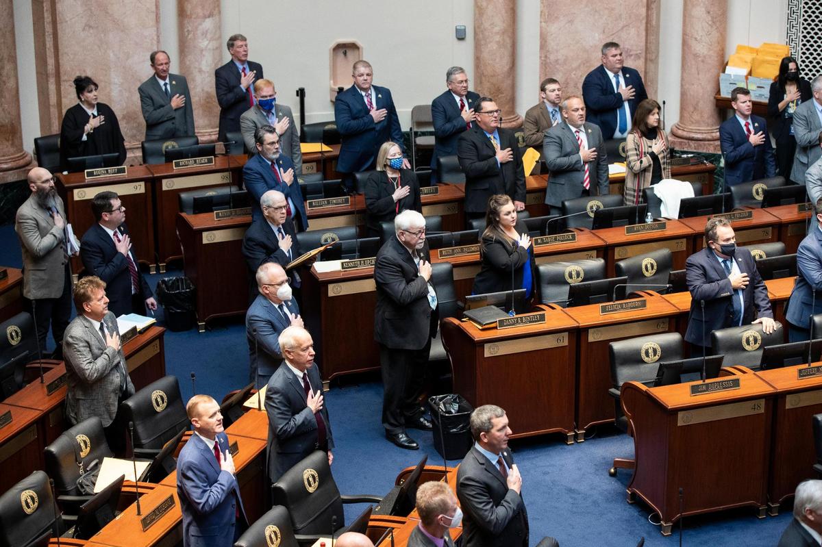 The Kentucky House of Representatives stands for the pledge of allegiance during the first day the Kentucky General Assembly 2022 session at the Capitol in Frankfort, Ky., Tuesday, January 4, 2022.