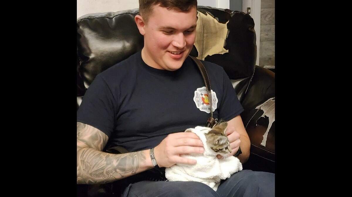A Lexington firefighter takes care of a kitten that was rescued from a storm drain at the intersection of Richmond Road and Mt. Tabor Road on July 16, 2024.