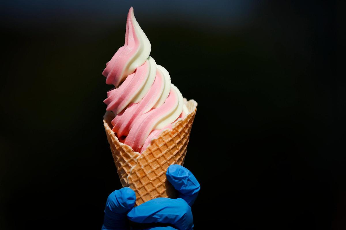 Hoggy’s Ice Cream owner Crissy Hogsten holds a cone of strawberry lime Dole Whip Oct. 6 in front of Hoggy’s. The Frankfort ice cream shop rotates the flavors of the popular soft serve that can be found at Disney parks.