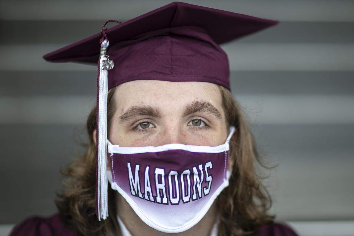 Jett Phillippi poses for a photo after attending a “drive-thru” graduation at Pulaski County High School in Somerset, Ky., Wednesday, May 20, 2020.