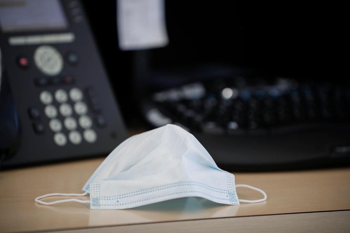 A medical mask sits on a desk Friday in the Volkswagen service center at Don Jacobs dealerships off Nicholasville Road in Lexington.