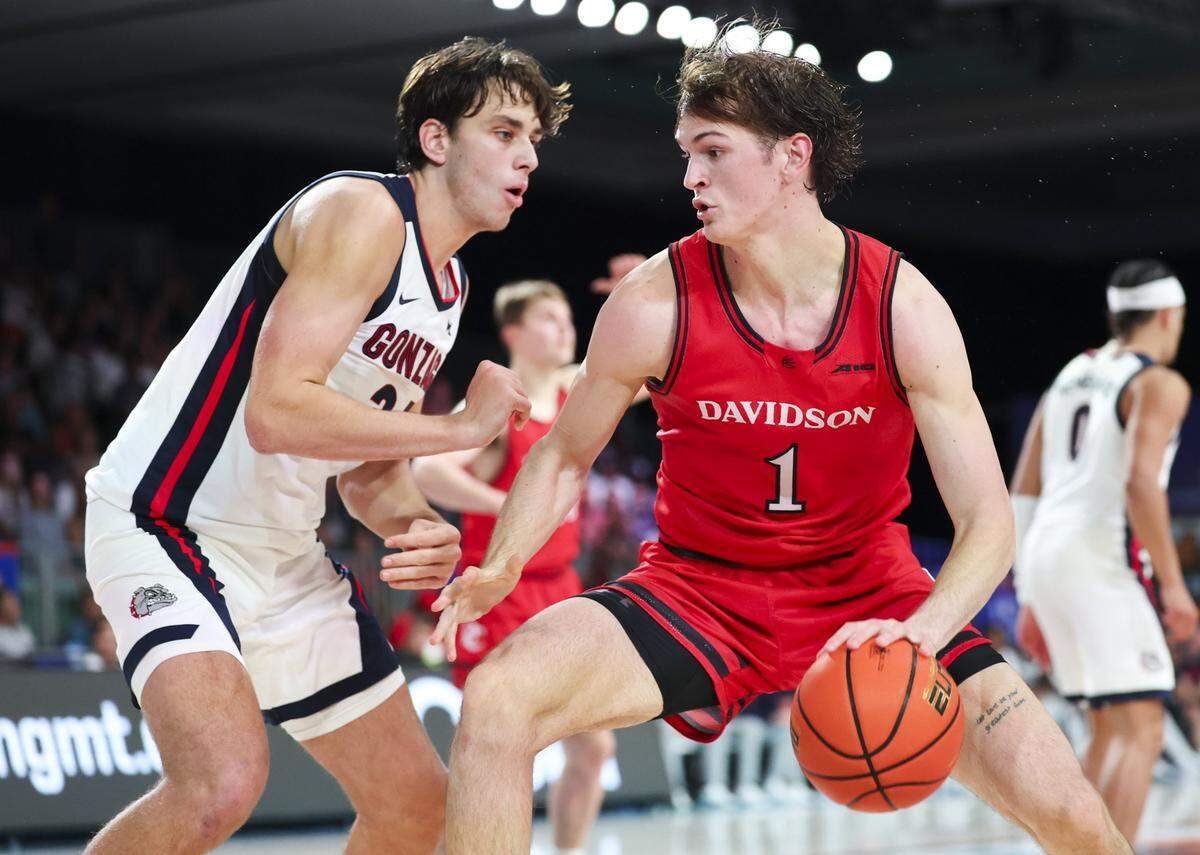 Nov 29, 2024; Paradise Island, Bahamas, BHS;  Davidson Wildcats forward Reed Bailey (1) dribbles as Gonzaga Bulldogs forward Braden Huff (34) defends during the second half at Imperial Arena at the Atlantis resort.  Mandatory Credit: Kevin Jairaj-Imagn Images