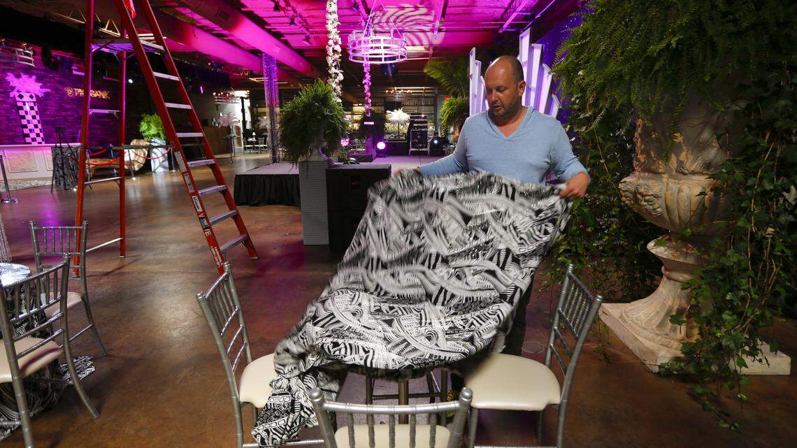 Phillip Marcum draped a tablecloth over a table as preparations continued Thursday for the JustFundKY party to be held at the Grand Reserve, 903 Manchester Street. Party organizers are determined to bring the fun and excitement of extravagant Derby Eve parties back to Lexington.
