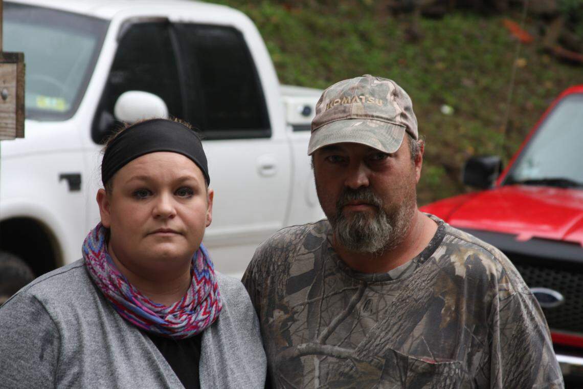 Jessica and Tim Taylor of Martin County collect water in buckets to deal with long water outages that have plagued their family.