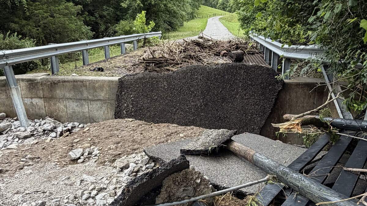 A residential driveway near Tates Creek Road in Madison County, Kentucky, is destroyed by floods on Saturday. At least five people were killed and dozens were missing following severe storms in Kentucky and Tennessee that triggered flash floods and washed out roads.
