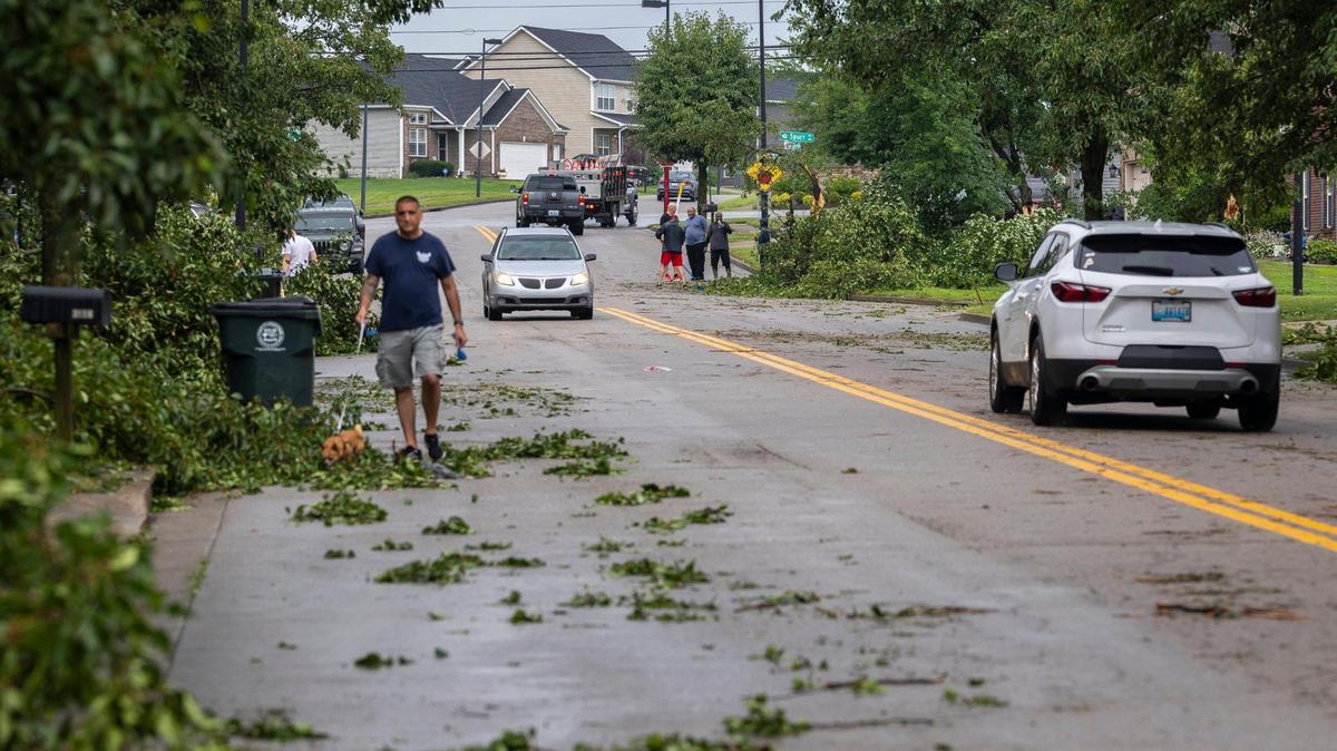 Residents work to remove tress, branches and other debris along Sandersville Road in Lexington, Ky., on Thursday, June 26, 2025, following a storm with strong winds.
