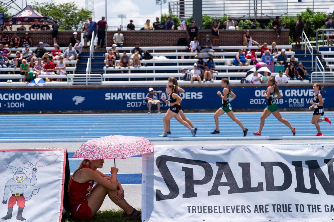 Hancock County’s Alex Kratzer shades herself with an umbrella between her events during the KHSAA Class 1A State Track Championship Meet at the University of Kentucky track complex in Lexington, Ky., Thursday, June 10, 2021.