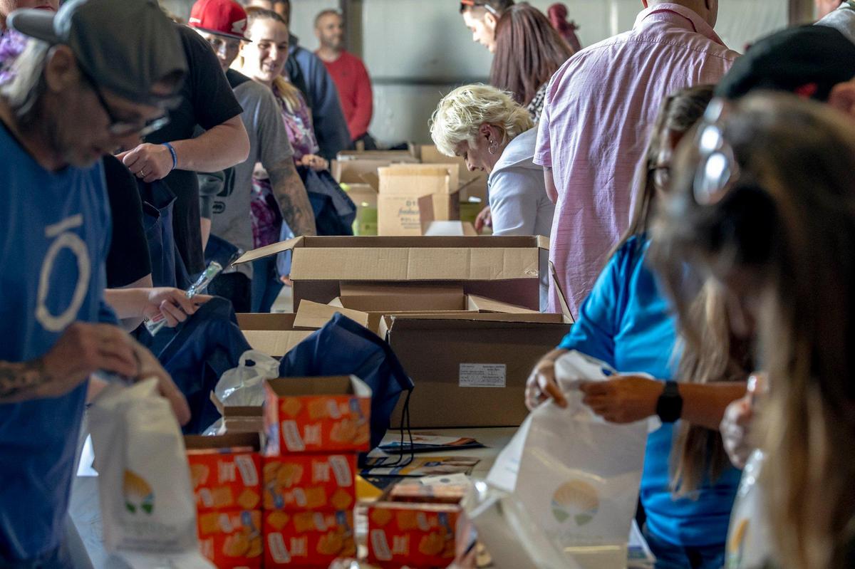 Personal hygiene items, food and other supplies are added to hygiene and necessity bags prepared at the Recovery Cafe in Lexington, Ky., on Friday, April 18, 2025. Nearly 200 bags were prepared and distributed during Lexington Community Partner Street Outreach Day.