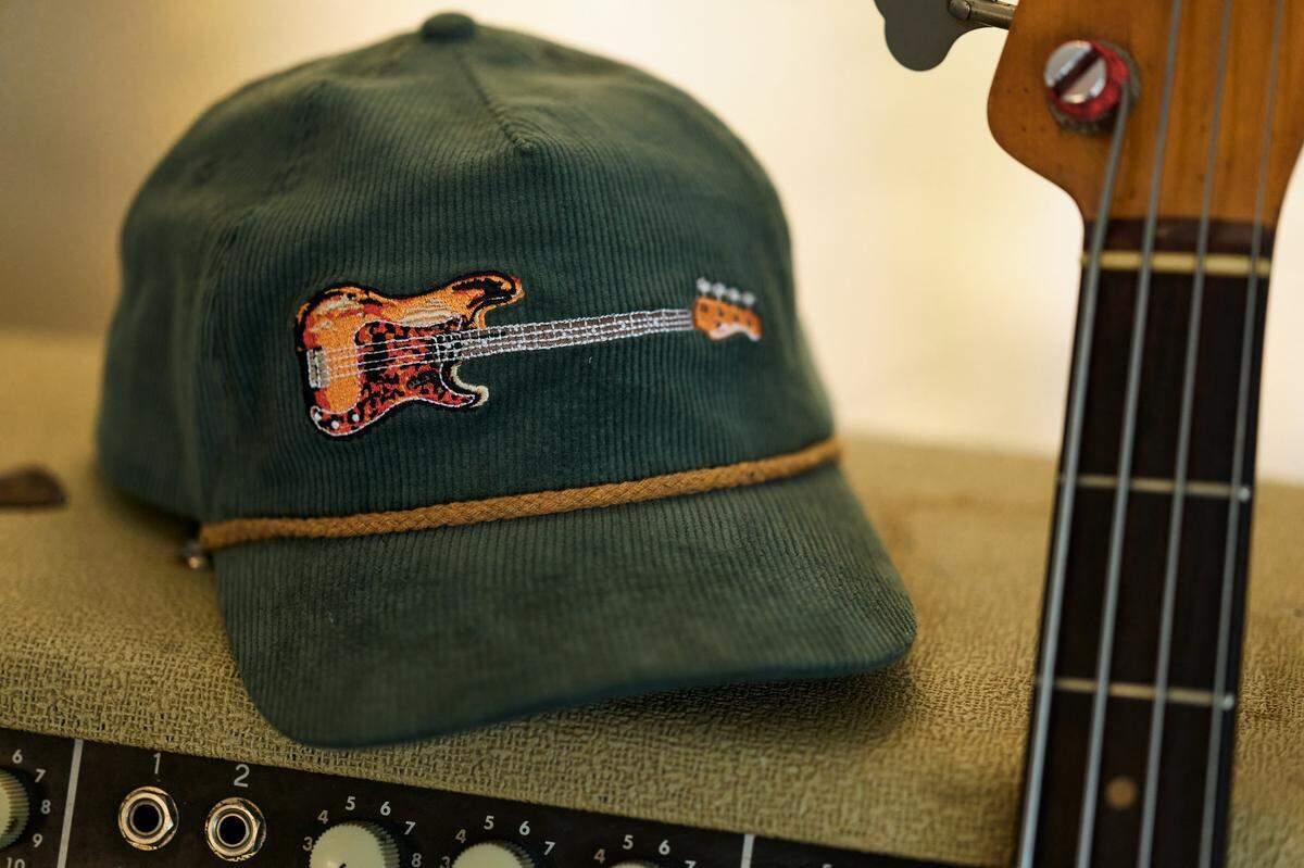 Proceeds from the sale of hats featuring J.T. Cure’s bass guitar “Purdy” will go to Chris and Morgane Stapleton’s Outlaw State of Kind charitable fund, which has helped Eastern Kentucky flood victims, among others.