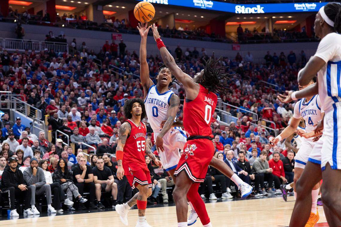 Kentucky’s Rob Dillingham (0) drives against Louisville’s Mike James (0) during Thursday’s game at the KFC Yum Center.