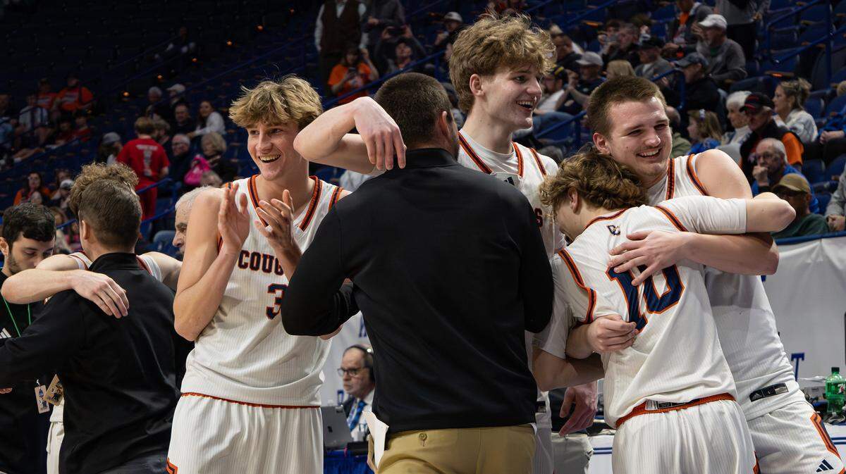 The Grayson County Cougars hug and celebrate their 58-50 victory over Great Crossing following the UK HealthCare Boys' Basketball Sweet 16 state tournament quarterfinals matchup at Rupp Arena in Lexington, Ky, on March 20, 2026.