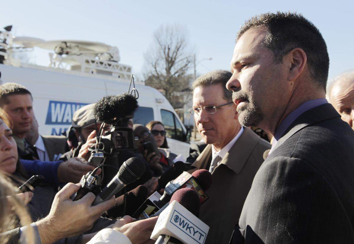 Richie Farmer, right, speaks to the press with his lawyer, Guthrie True, center, outside the federal courthouse in Frankfort on Jan. 14, 2014. Farmer was sentenced to 27 months in prison after pleading guilty to misusing state resources during his tenure as Kentucky's agriculture commissioner.