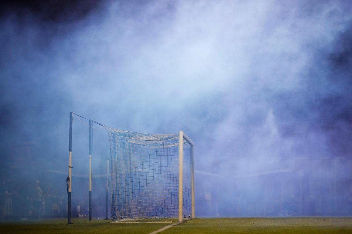 Celebratory blue smoke floats onto the field after Kentucky scored against Louisville on Tuesday night.