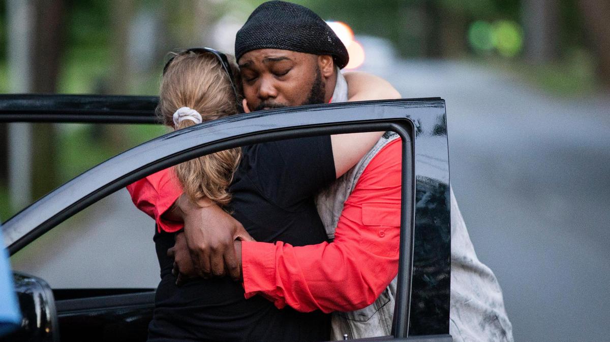 Sondra Morgan receives a hug from Sterling Ray Ward Jr. during a vigil for her husband, Daezon Morgan, at the intersection of Richmond Rd and Preston Ave in Lexington, Ky., Monday, June 15, 2020. Morgan died after being stuck by a man accused of driving under the influence on Monday, June 8, 2020.