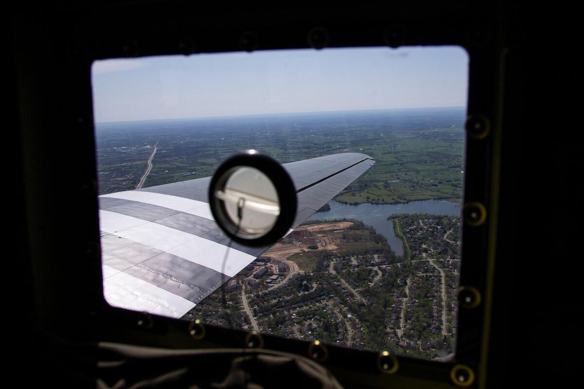 The view of above Lexington out the window of C-47 “That’s All Brother” as it flies above central Kentucky after taking off from the Blue Grass Airport Friday.