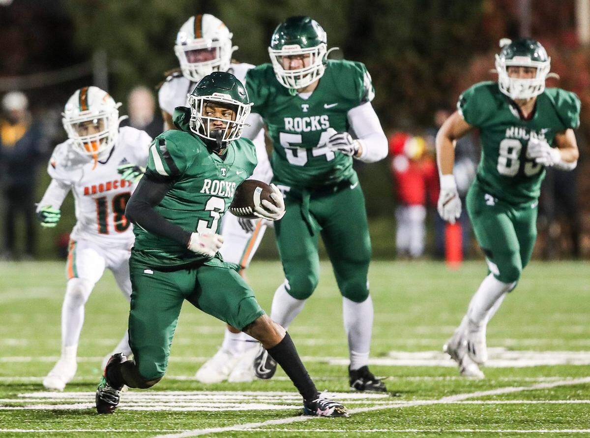 Trinity’s Jeremiah Lynn looks for room to run against the Frederick Douglass defense but found little Friday night. The Broncos limited the Shamrocks to 49 yards rushing and 100 yard passing.