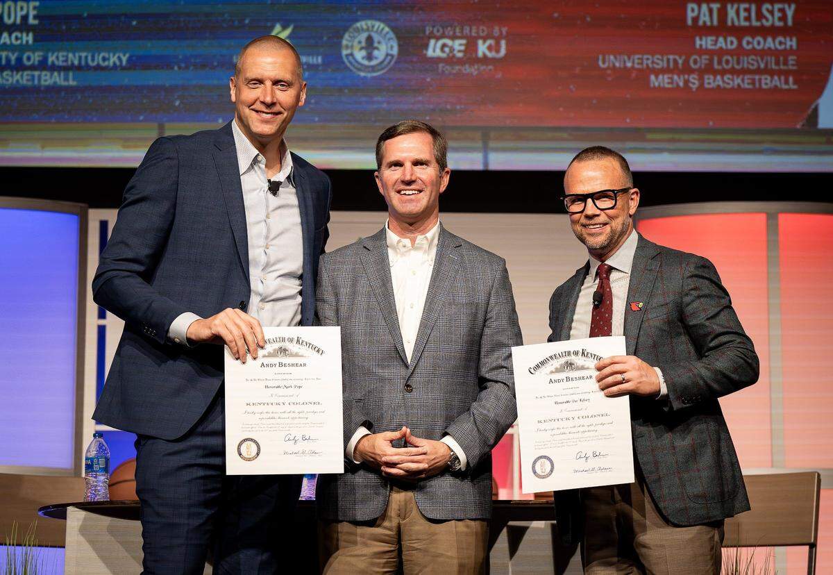 New Kentucky coach Mark Pope, left, and new Louisville head man Pat Kelsey, right, will face each other in the UK-U of L rivalry for the first time Saturday. Kentucky Gov. Andy Beshear, center, could be among those in attendance at Rupp Arena.