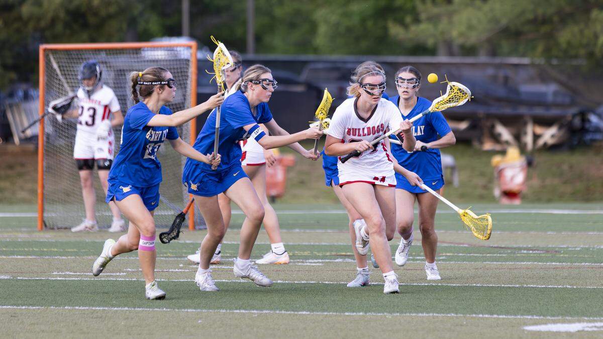 Henry Clay players including, from left, Vonnie Allen-Guy (23), Audrey Webster and Molly Pugh, chase down Paul Laurence Dunbar’s Tori Hall during the Blue Devils’ 10-3 win at Paul Laurence Dunbar High School on Monday.