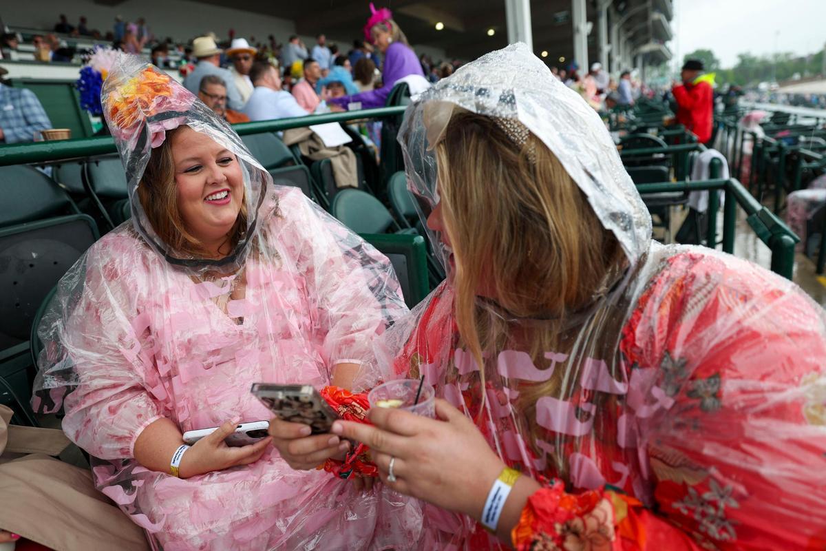 Lexington residents LaKole Wichita and Katie Wichita try to stay dry during Kentucky Derby 151 at Churchill Downs May 3, 2025.&nbsp;&nbsp;
