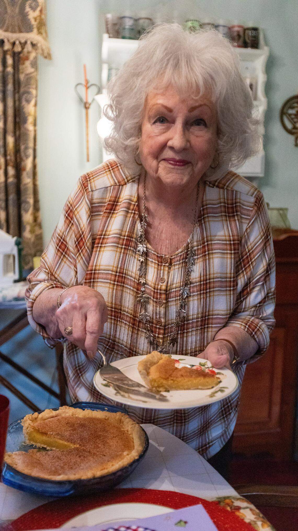Barbara Harper Bach, 87, holding a slice of chess pie she made from a family recipe passed down to her. November 7, 2025.