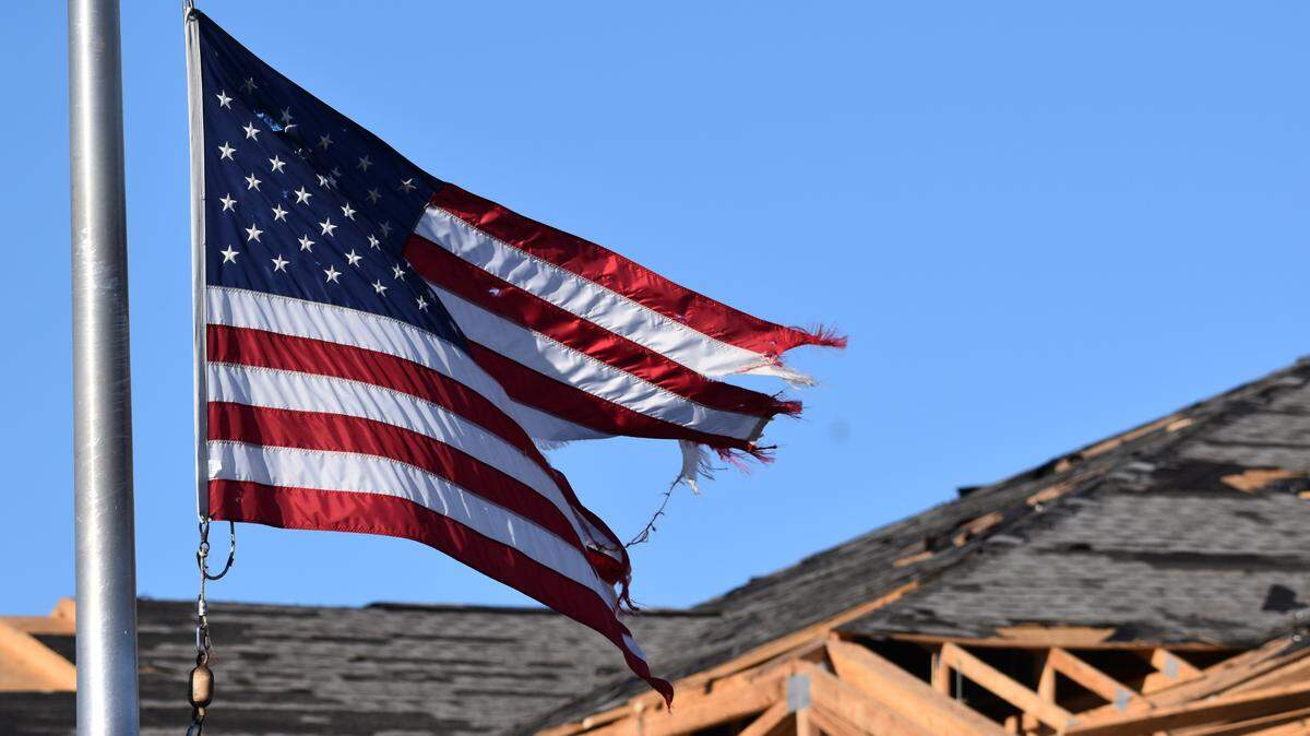 A U.S. flag still flew over First National Bank in Mayfield after a devastating tornado destroyed much of downtown.