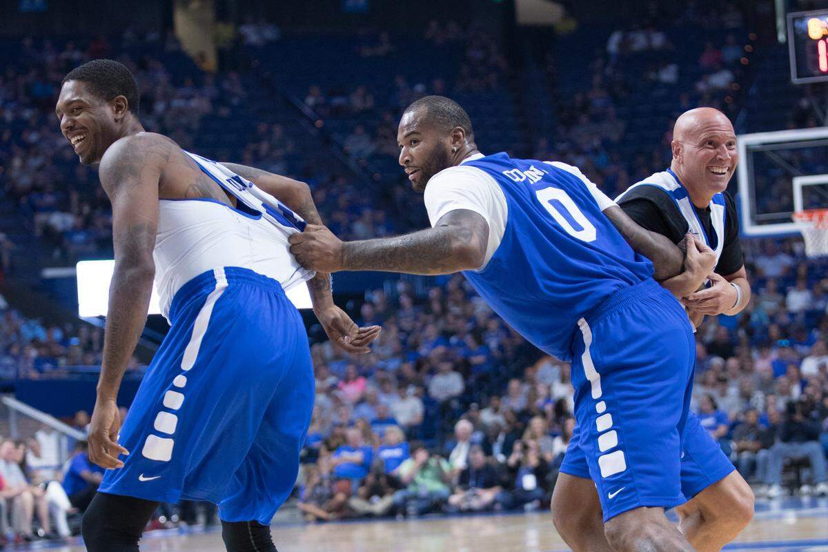 Erik Daniels and Rex Chapman were defended by DeMarcus Cousins during the UK Alumni Charity basketball game in Rupp Arena in 2017.