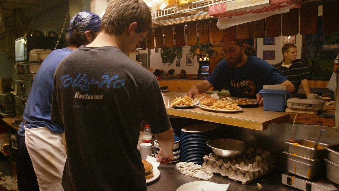 Aaron Milling, in the Tolly-Ho shirt, and Reat Haynes, in the bandanna, worked the kitchen at Tolly-Ho as Andrew Cook picked up an order. The popular restaurant will be moving in January to the former Hart's Dry Cleaning building on South Broadway.  