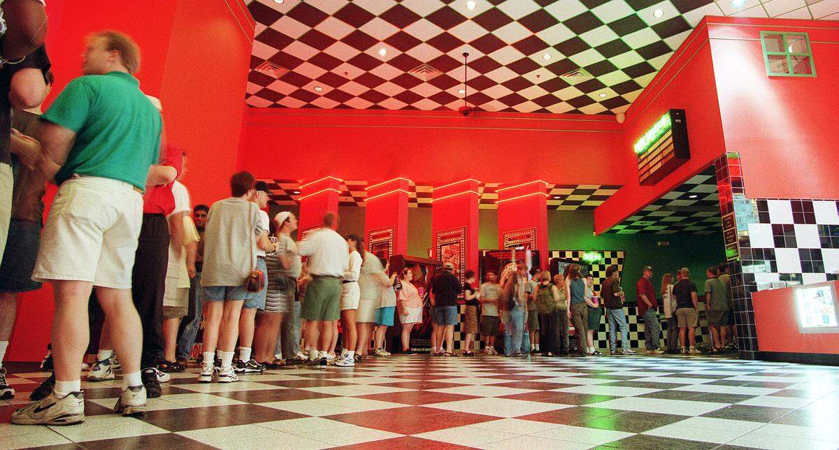 A large crowd in line at the movie theater in Woodhill to see the 9:55 p.m. showing of “Godzilla”, May 19, 1998. The theater, run by Cinemark, closed on Sept. 5, 1998. The 10-screen theater was once one of the top movie destinations in Lexington. The closing left Lexington will only four first-run movie theaters: The Kentucky Theatre on Main Street, Cinemark at Fayette Mall, Regal at Hamburg and Movie Tavern at Brannon Crossing. In May 1998, it became the first theater in Lexington to get stadium seating, with rising levels of seats.