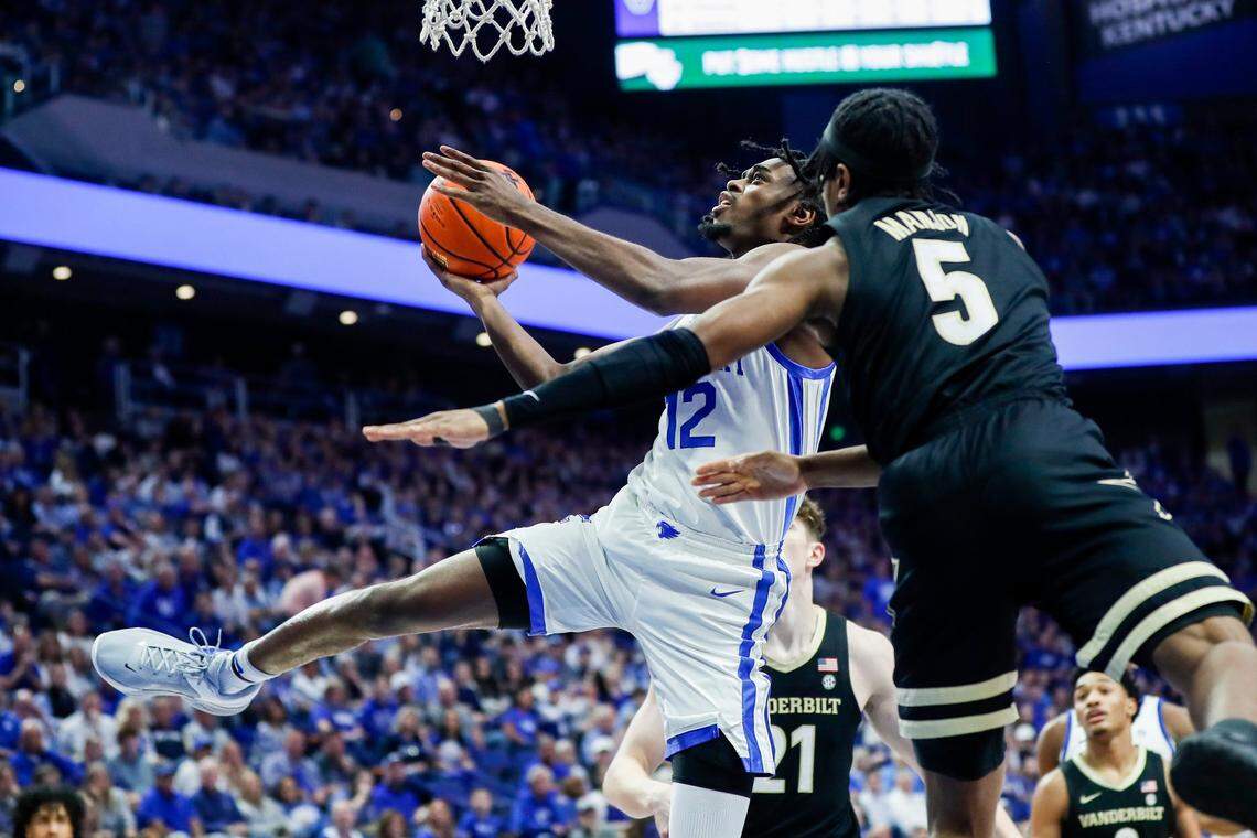 Kentucky’s Antonio Reeves (12) drives against Vanderbilt’s Ezra Manjon (5) on Wednesday night. Reeves finished with 14 points.