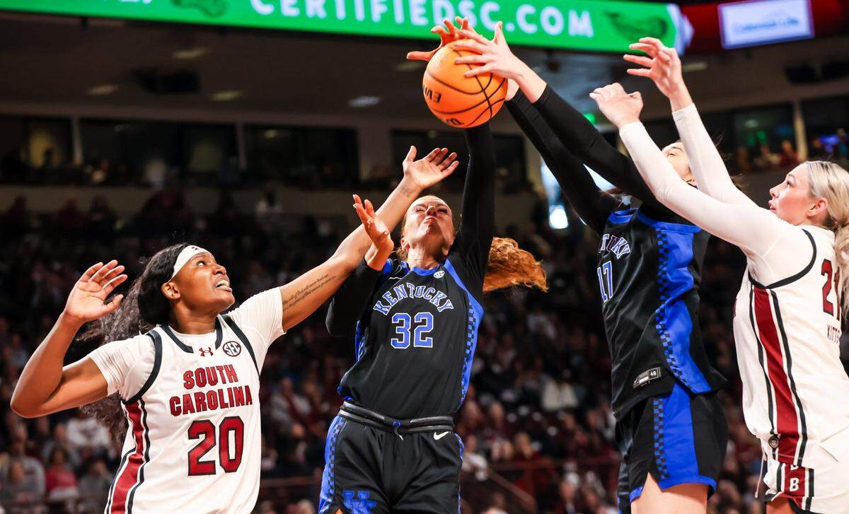 Mar 2, 2025; Columbia, South Carolina, USA; South Carolina Gamecocks forward Sania Feagin (20) and forward Chloe Kitts (21) battle Kentucky Wildcats forward Amelia Hassett (32) and center Clara Silva (17) for a rebound in the first half at Colonial Life Arena. Mandatory Credit: Jeff Blake-Imagn Images