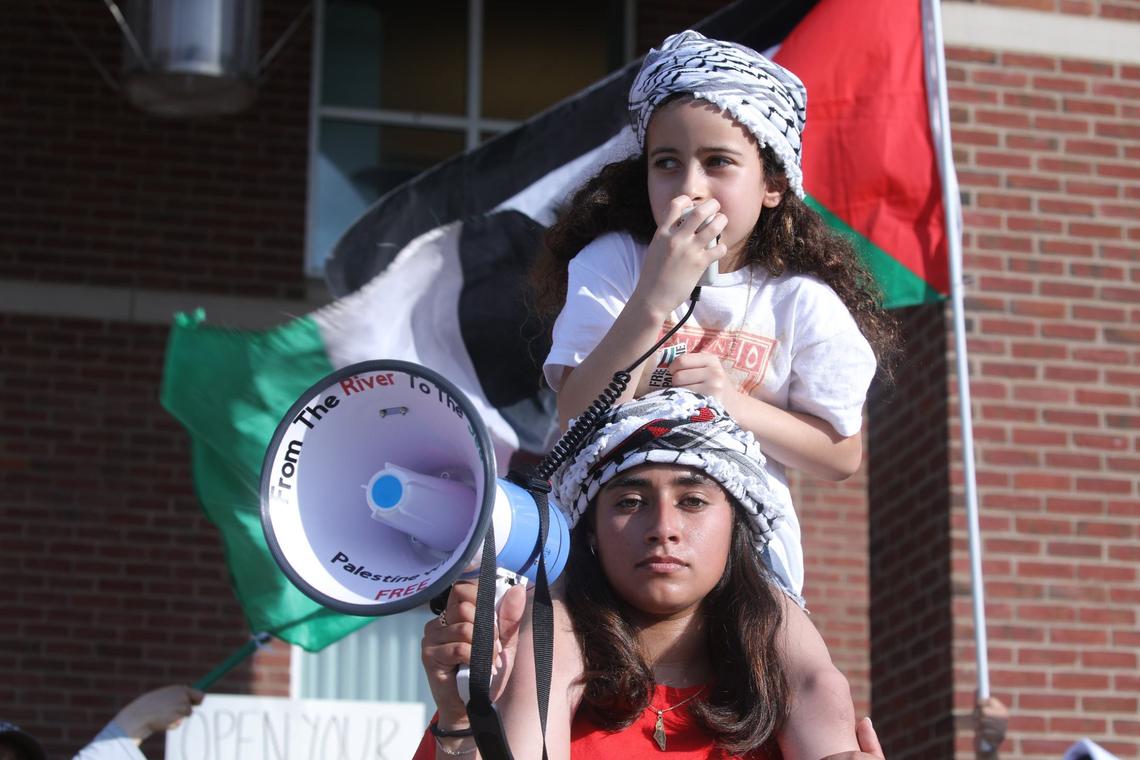 Young rally participant leading rally chants with megaphones during the peaceful Free Palestine rally at the William T Young Library lawn on UK’s campus on May 1, 2024, in Lexington, Ky.