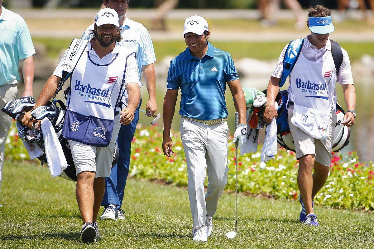 Andres Romero, center, walked with caddy Angel Monguzzzi, right, after sinking a putt on the 18th green during the PGA Tour Barbasol Championship at Keene Trace Golf Club Thursday in Nicholasville. Romero finished 7 under for the day. 